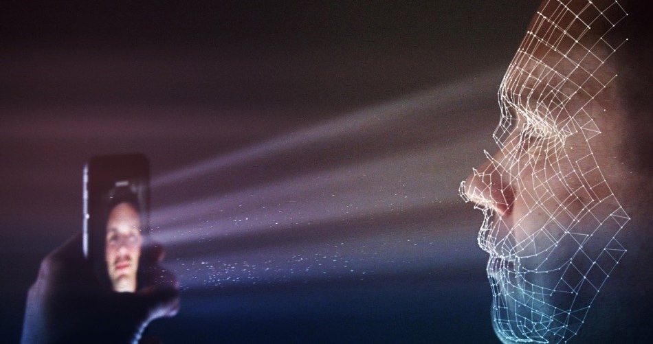 Illustration of smart phone facial recognition, where an NIR structured light pattern is projected towards a person’s face, reflecting off the contours of their features to create a 3D image.