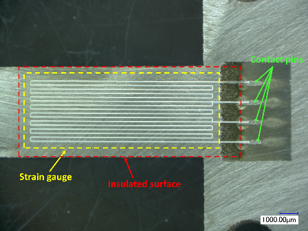 Printed insulation and strain gauge by AerosolJet Printing on a 300 µm-thick flexure element.
