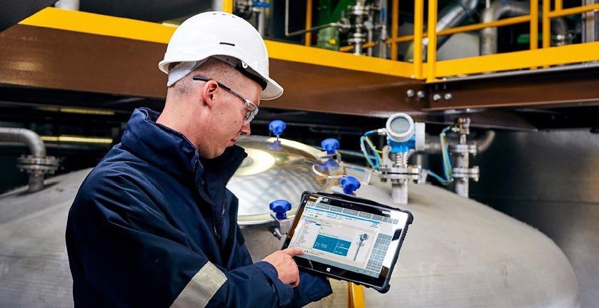 Figure 3: With Bluetooth wireless communications, a technician with a handheld device — such as an Endress+Hauser Field Xpert® SMT70 tablet PC tool can activate a proof test from up to 40 feet away from the level instrument, making it easier to perform tests on level instruments installed at the top of tanks or in inaccessible locations.