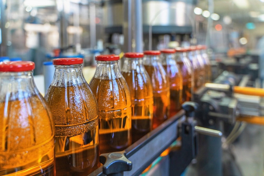 conveyer belt, bottles of beverage