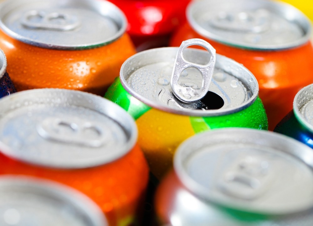 Cans of sweet drinks (or beer). Cooling frozen and with water drops