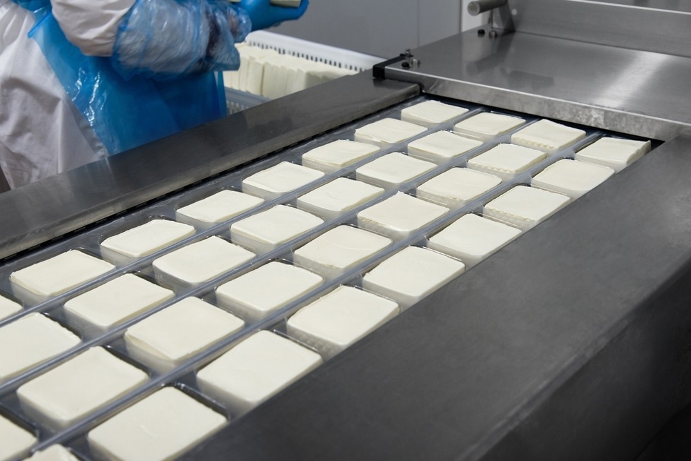 Cow cheese making, white feta, mozzarella, cheese production line.