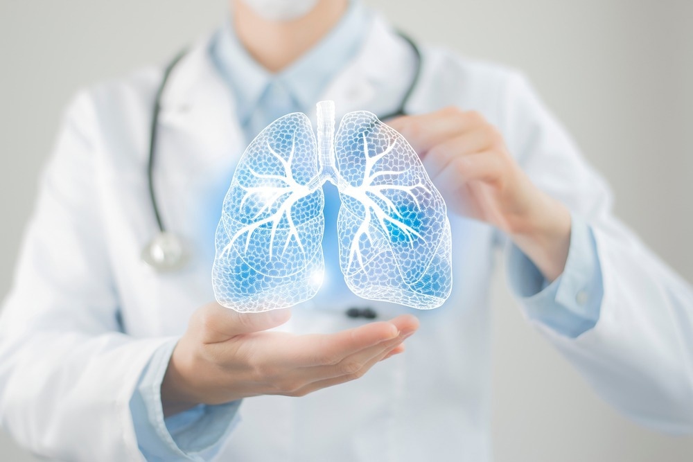 Female doctor holding virtual Lungs in hand. Handrawn human organ, copy space on right side, raw photo colors.