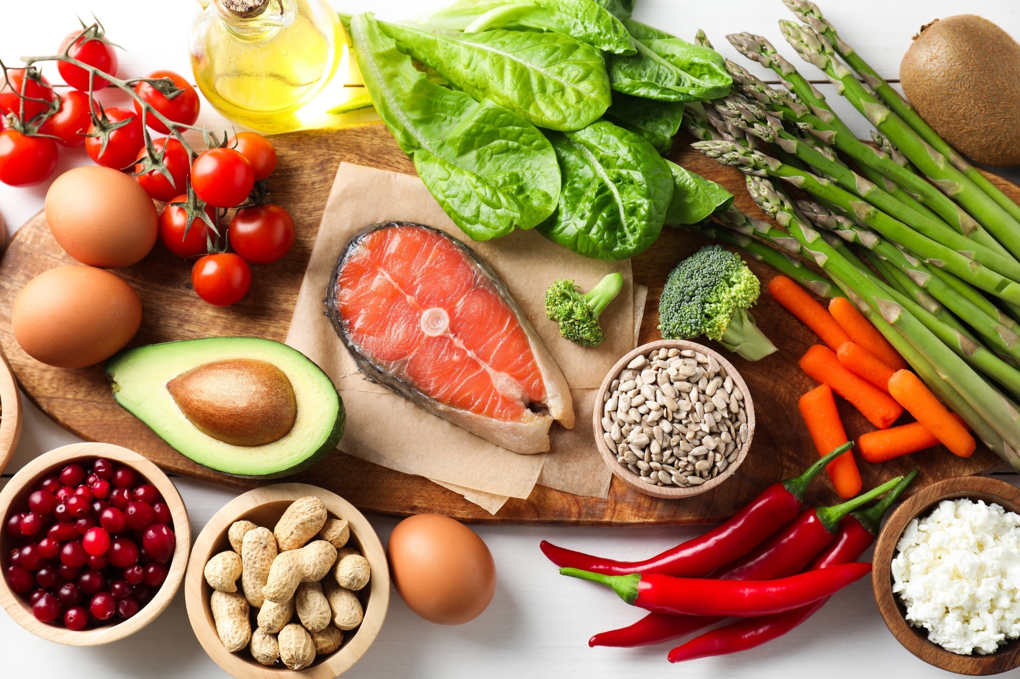 Many different healthy food on white table.