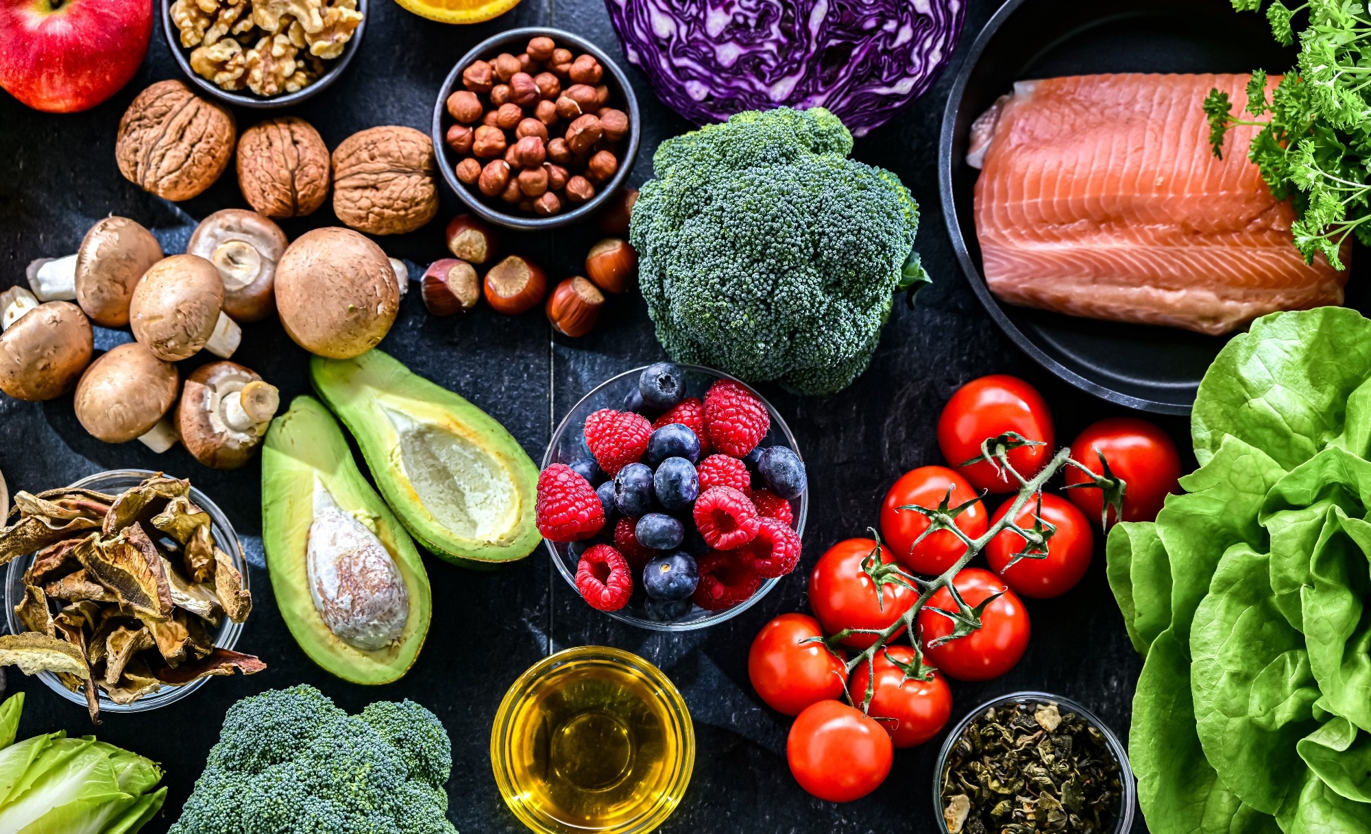A spread of different types of food, including salmon, fruit and veg.