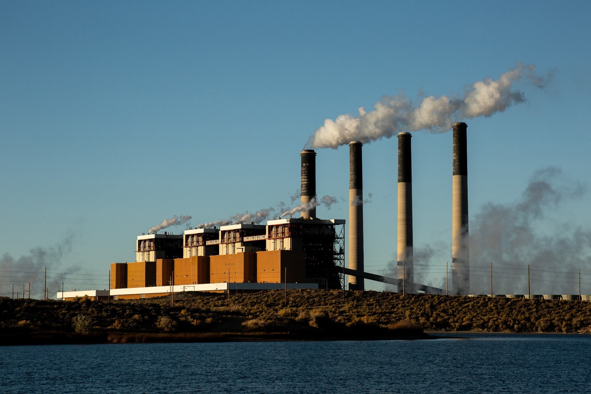 Emissions from a factory, three chimneys emitting gases.
