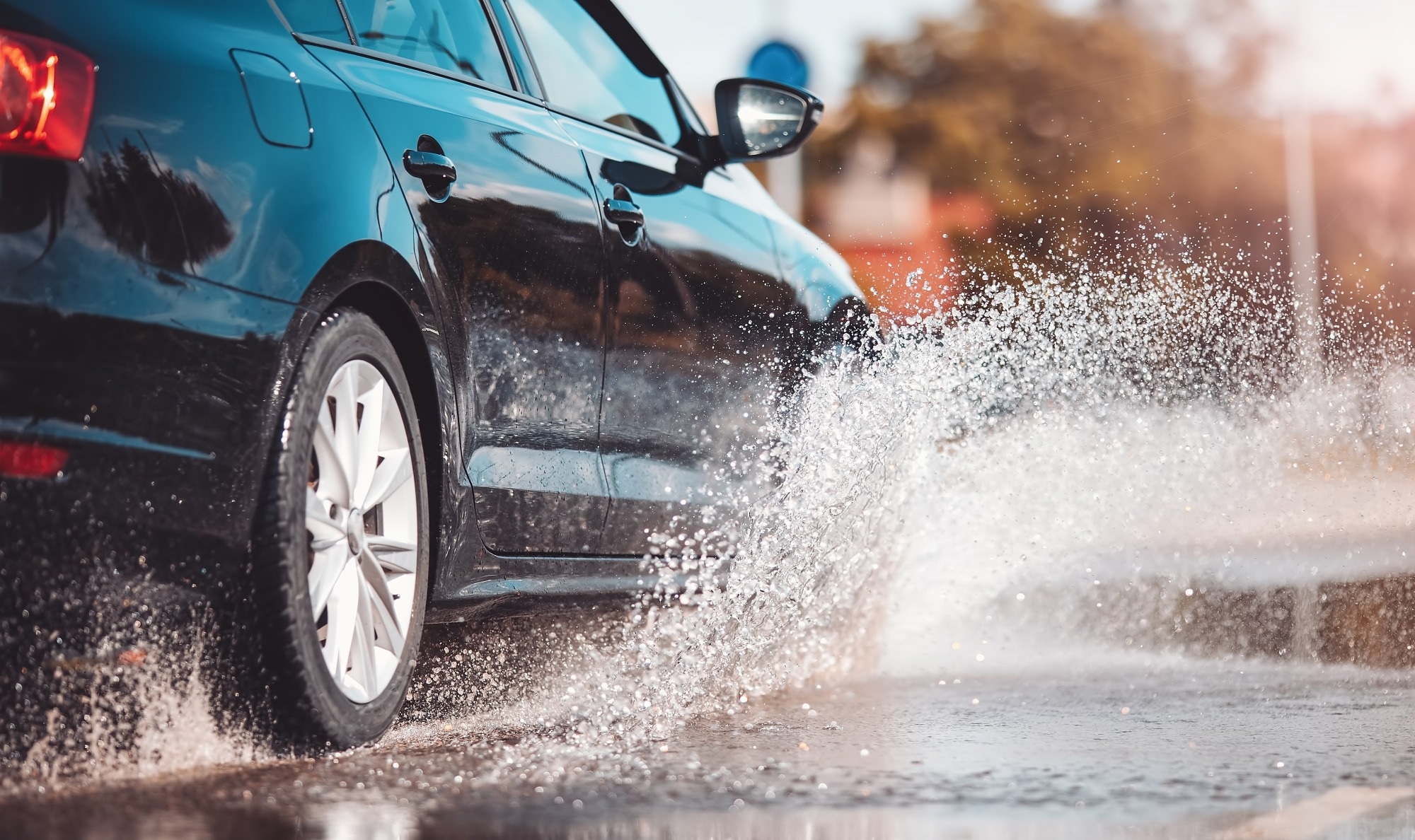 A car driving through a puddle of water.