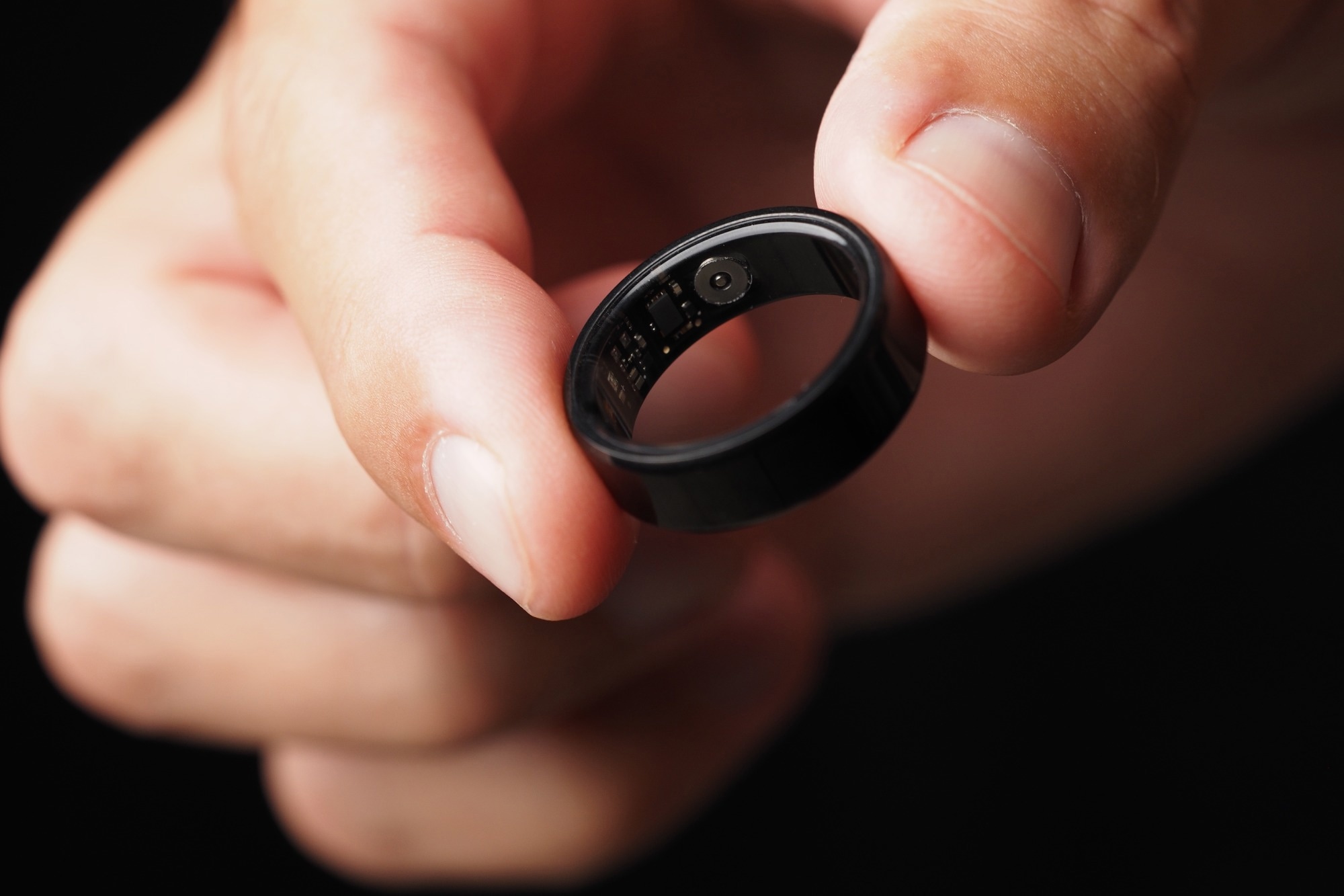 A man holds a smart sensing ring.