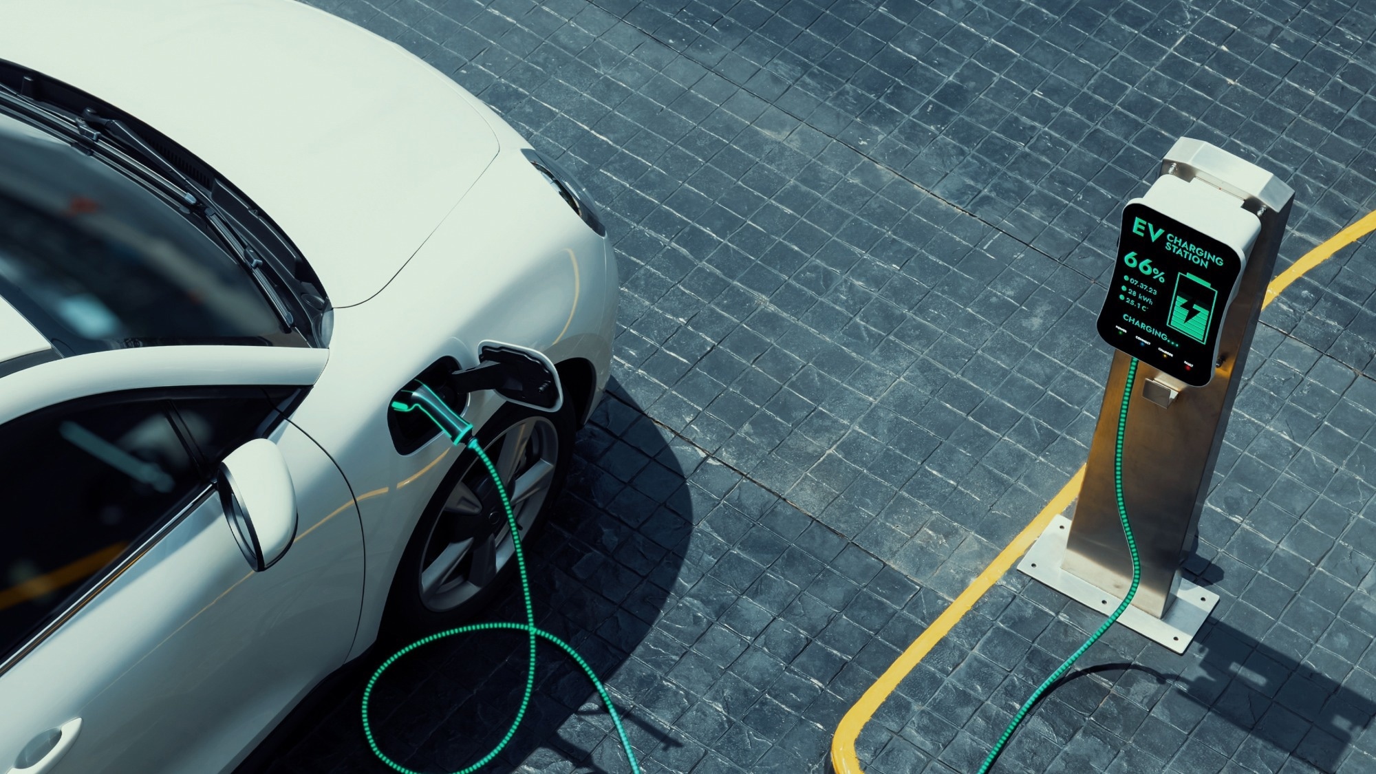 Aerial view electric car recharging battery from EV charging station.