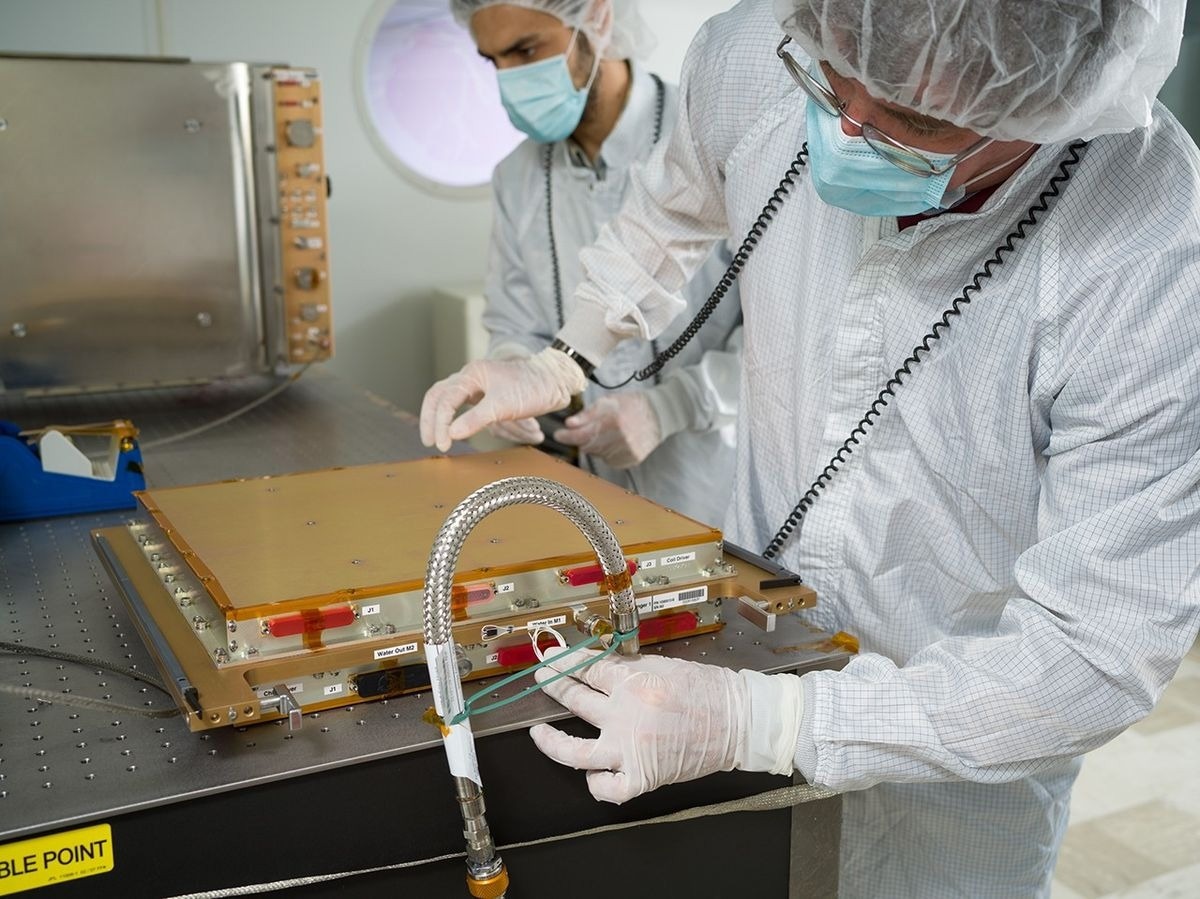 Upgraded hardware being prepared at Jet Propulsion Lab for launch and install into the Cold Atom Lab on the International Space Station. The Science Module in the background enables CAL researchers to conduct atom interferometry research in Earth’s orbit.