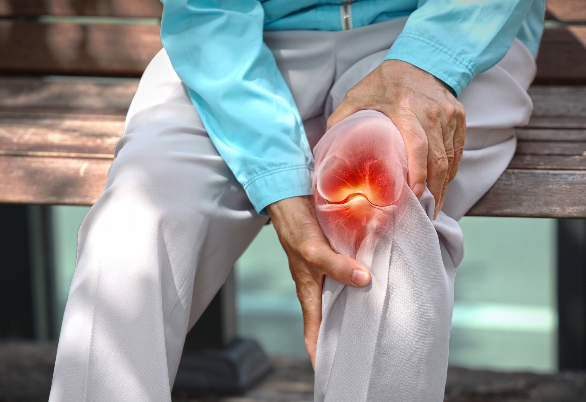 Close up of elderly woman holding knee with pain due to degenerative arthritis