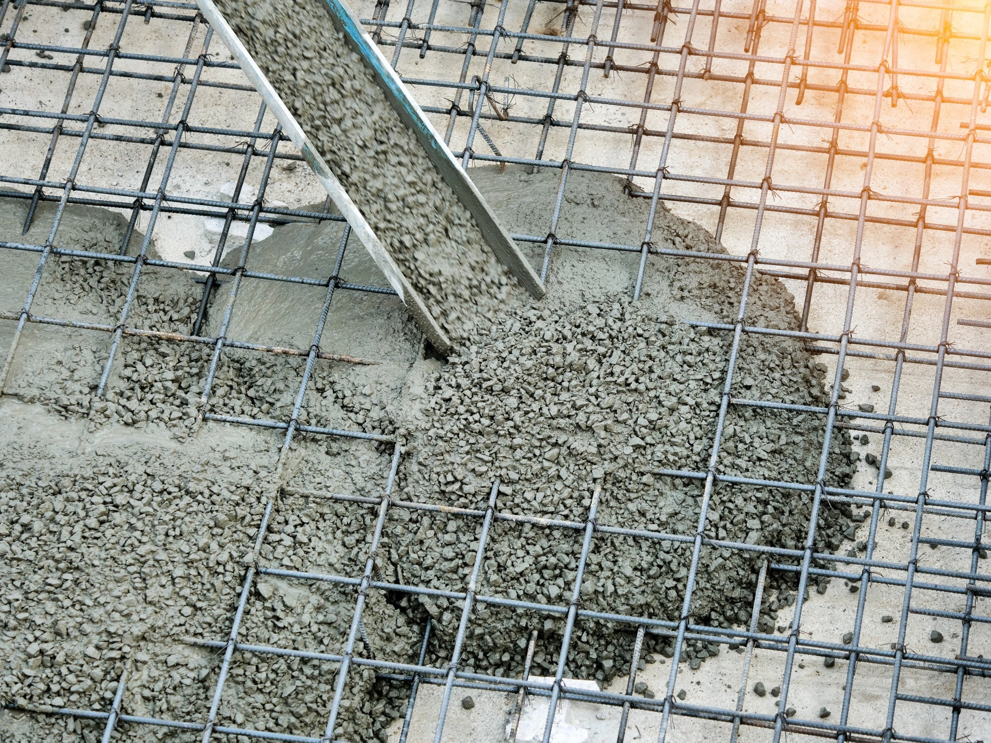 Concrete pouring during commercial concreting floors of buildings in construction site.
