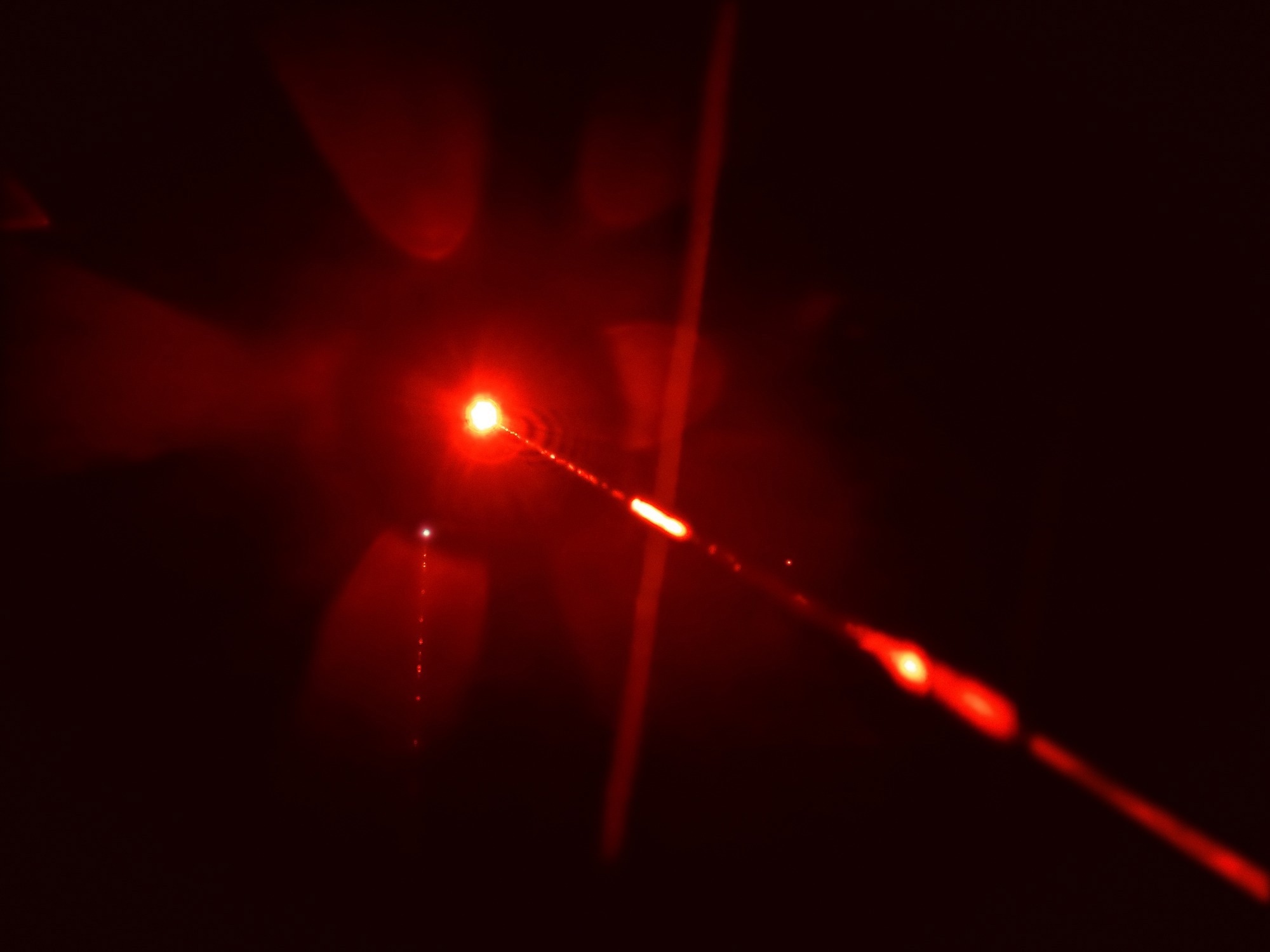 Close up of a red laser beam.