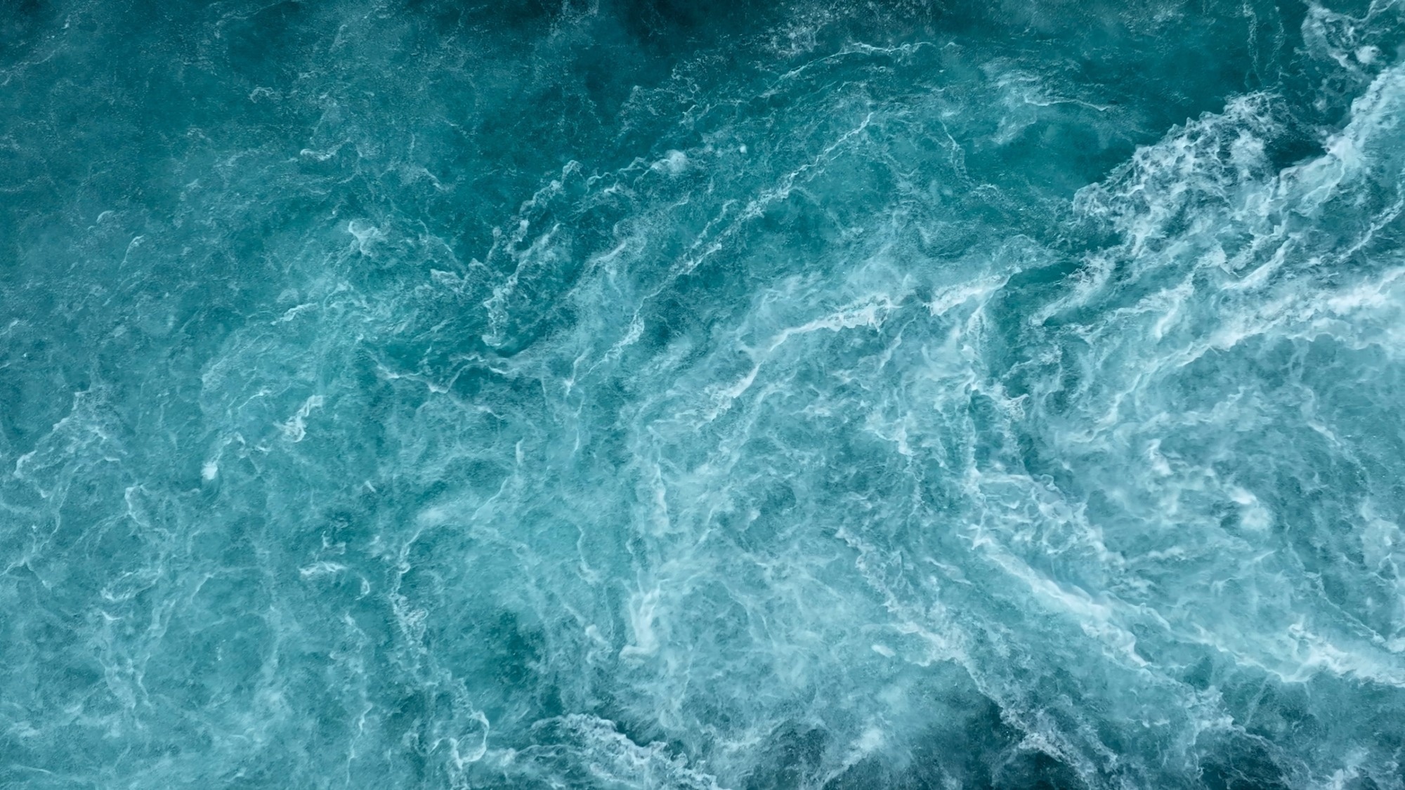 Aerial view of the waves and rapids of the wild river, close-up, top shot.