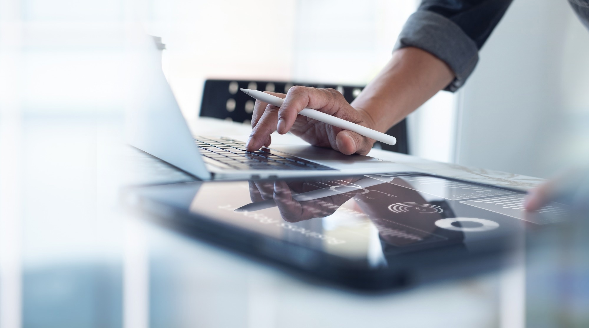 Person using computer and touch screen with a touch screen pen.