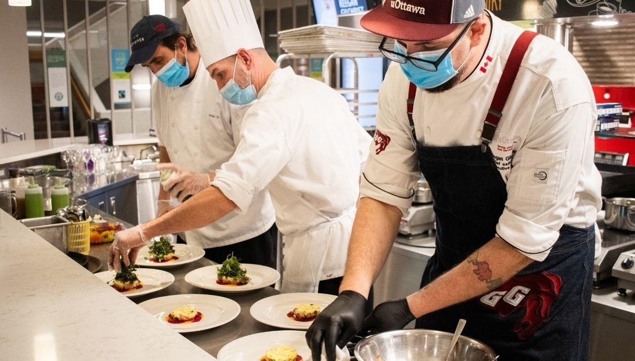 a group of men cook in a restaurants