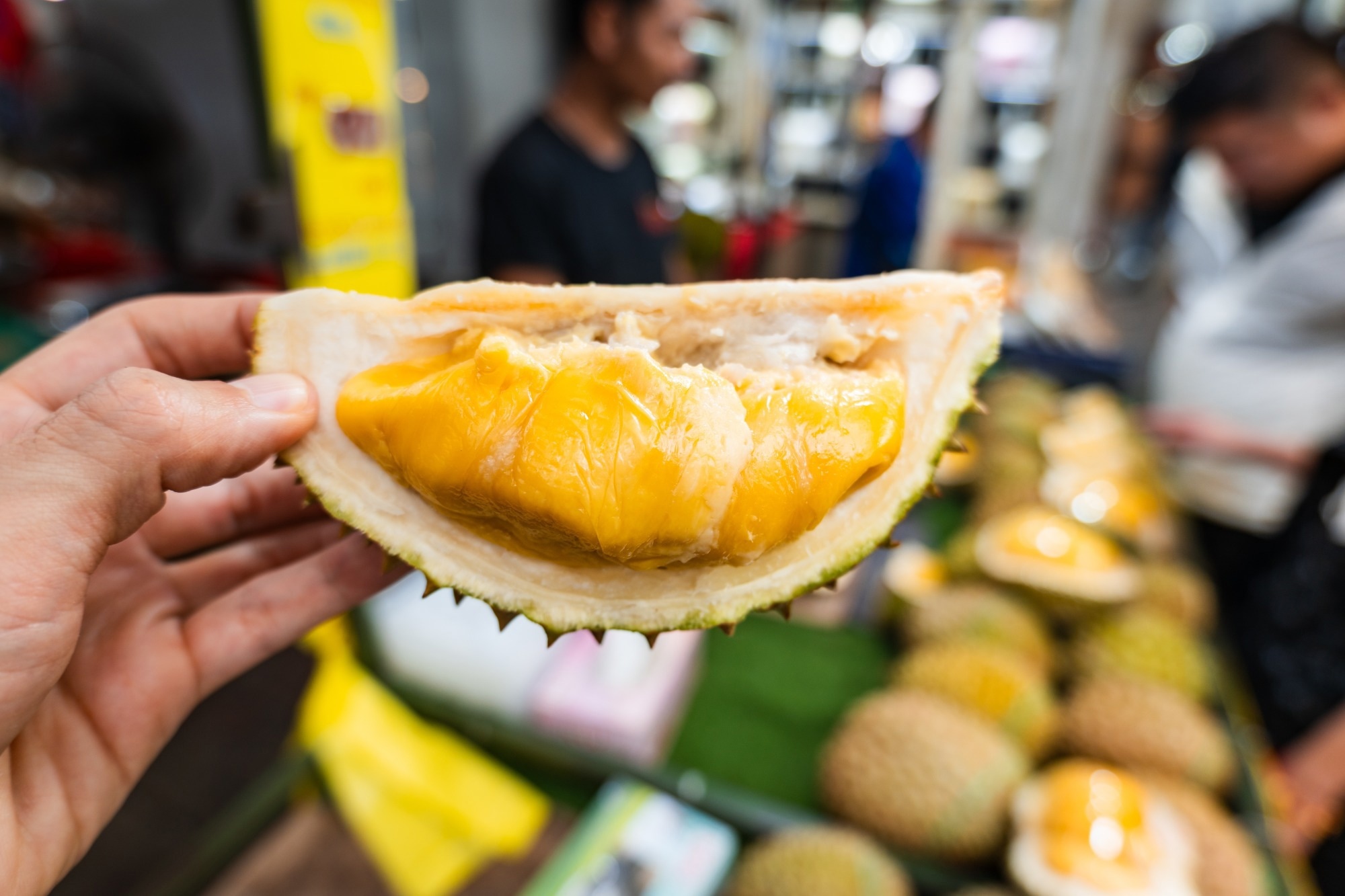 Durian fruit close-up in front of a market stall